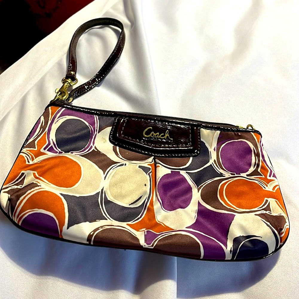 Monogrammed multi colored Coach wristlet used a few but in good condition